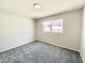 an empty room with a window and concrete floor at BLVD Apartments LLC, Tarzana, CA 91356